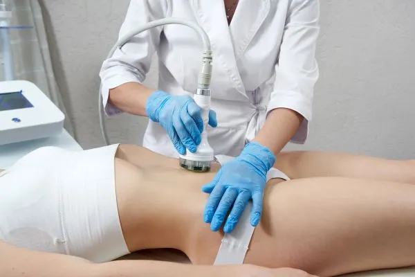 Lost the Weight but Not the Loose Skin? 2 woman having HIFU treatment on her stomach to combat loose skin West Malling following weight loss
